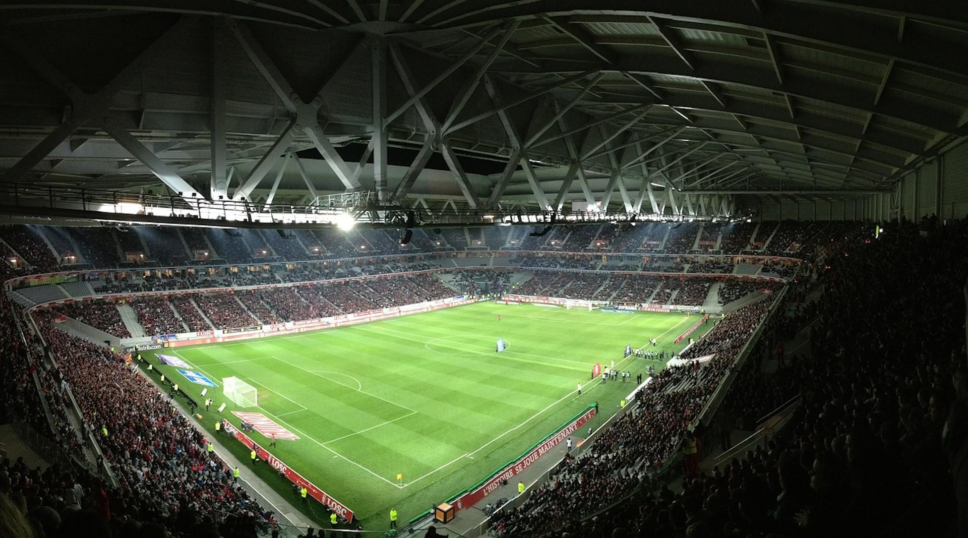 Spectator view of football pitch inside roof covered football stadium